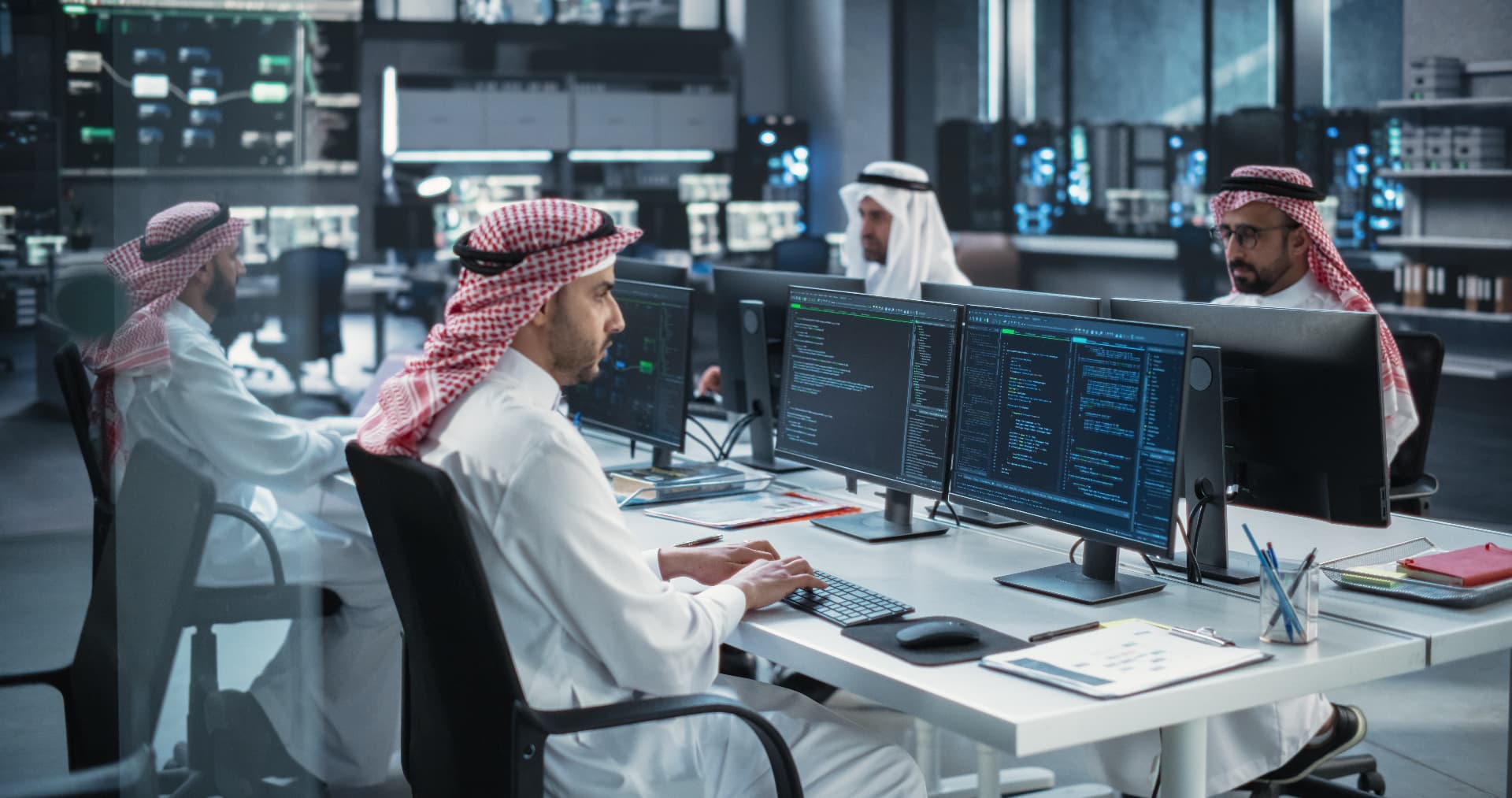 Saudi professionals reviewing a customer intelligence dashboard
