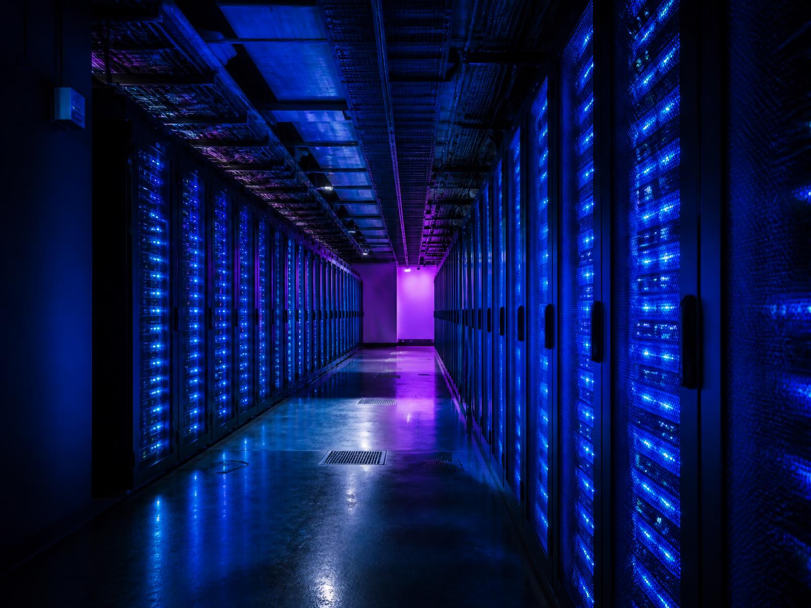 Illuminated server racks inside a modern data center